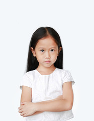 Cute little hispanic Asian child girl with arms crossed and angry about something over white background with looking at camera. Person with Negative emotion concept.