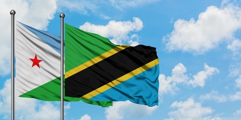 Djibouti and Tanzania flag waving in the wind against white cloudy blue sky together. Diplomacy concept, international relations.