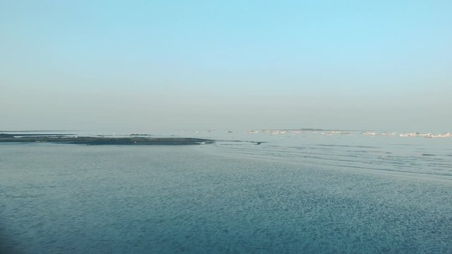 gorai beach black sand blue sky reflecting on a wet sand long shot.