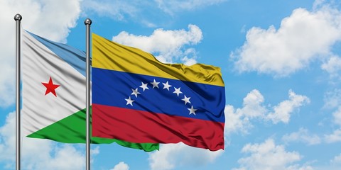 Djibouti and Venezuela flag waving in the wind against white cloudy blue sky together. Diplomacy concept, international relations.