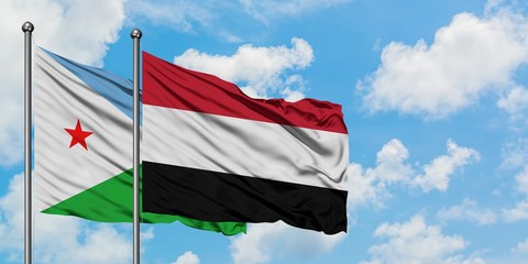 Djibouti and Yemen flag waving in the wind against white cloudy blue sky together. Diplomacy concept, international relations.