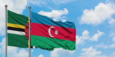 Dominica and Azerbaijan flag waving in the wind against white cloudy blue sky together. Diplomacy concept, international relations.