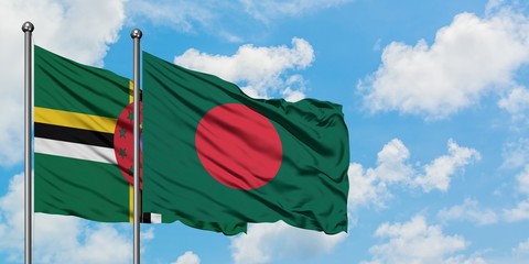 Dominica and Bangladesh flag waving in the wind against white cloudy blue sky together. Diplomacy concept, international relations.
