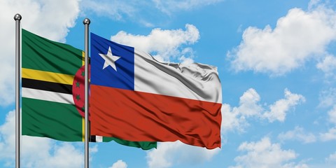 Dominica and Chile flag waving in the wind against white cloudy blue sky together. Diplomacy concept, international relations.