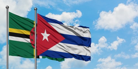 Dominica and Cuba flag waving in the wind against white cloudy blue sky together. Diplomacy concept, international relations.