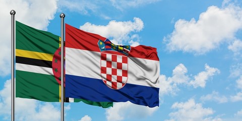 Dominica and Croatia flag waving in the wind against white cloudy blue sky together. Diplomacy concept, international relations.