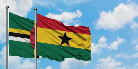 Dominica and Ghana flag waving in the wind against white cloudy blue sky together. Diplomacy concept, international relations.
