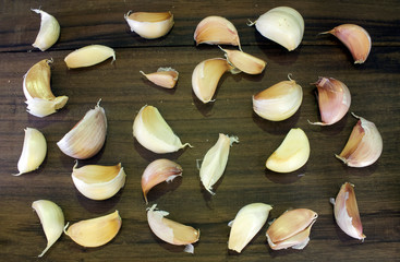 some fresh organic garlic unpeeled natural color that is different with vintage black wooden background