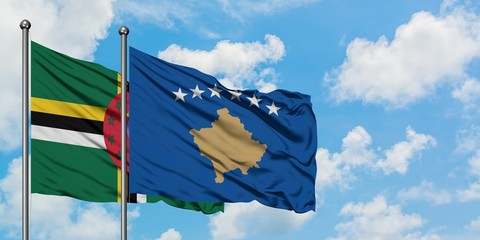 Dominica and Kosovo flag waving in the wind against white cloudy blue sky together. Diplomacy concept, international relations.