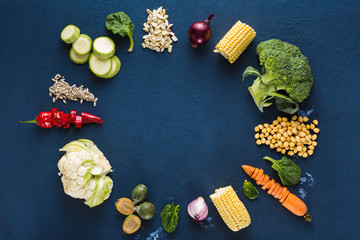 World vegan day. Frame of Fresh vegetarian ingredients for cooking vegan plate on dark background overhead view