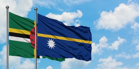 Dominica and Nauru flag waving in the wind against white cloudy blue sky together. Diplomacy...