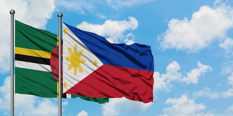 Dominica and Philippines flag waving in the wind against white cloudy blue sky together. Diplomacy concept, international relations.