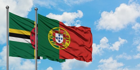 Dominica and Portugal flag waving in the wind against white cloudy blue sky together. Diplomacy...