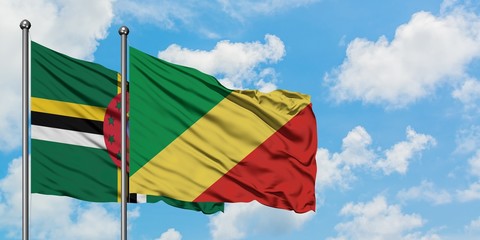 Dominica and Republic Of The Congo flag waving in the wind against white cloudy blue sky together. Diplomacy concept, international relations.