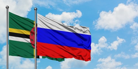 Dominica and Russia flag waving in the wind against white cloudy blue sky together. Diplomacy concept, international relations.