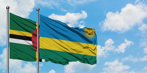 Dominica and Rwanda flag waving in the wind against white cloudy blue sky together. Diplomacy concept, international relations.