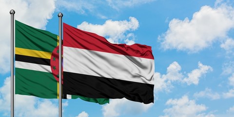 Dominica and Yemen flag waving in the wind against white cloudy blue sky together. Diplomacy...