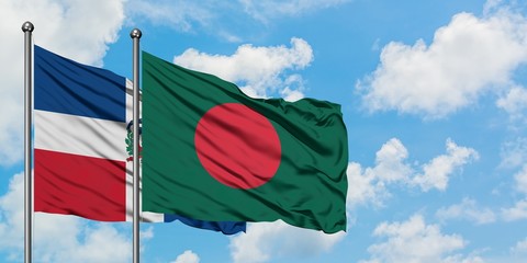 Dominican Republic and Bangladesh flag waving in the wind against white cloudy blue sky together. Diplomacy concept, international relations.