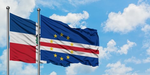 Dominican Republic and Cape Verde flag waving in the wind against white cloudy blue sky together. Diplomacy concept, international relations.