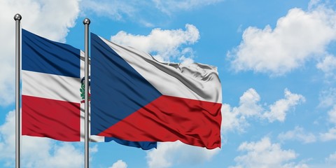 Dominican Republic and Czech Republic flag waving in the wind against white cloudy blue sky together. Diplomacy concept, international relations.
