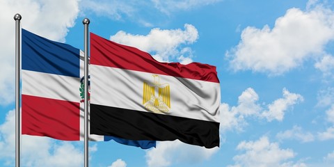 Dominican Republic and Egypt flag waving in the wind against white cloudy blue sky together. Diplomacy concept, international relations.