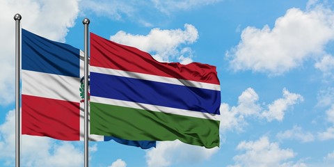 Dominican Republic and Gambia flag waving in the wind against white cloudy blue sky together. Diplomacy concept, international relations.