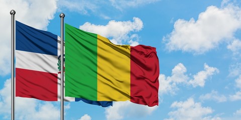 Dominican Republic and Mali flag waving in the wind against white cloudy blue sky together. Diplomacy concept, international relations.