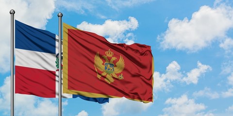 Dominican Republic and Montenegro flag waving in the wind against white cloudy blue sky together. Diplomacy concept, international relations.