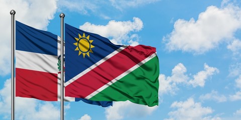 Dominican Republic and Namibia flag waving in the wind against white cloudy blue sky together. Diplomacy concept, international relations.