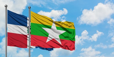 Dominican Republic and Myanmar flag waving in the wind against white cloudy blue sky together. Diplomacy concept, international relations.