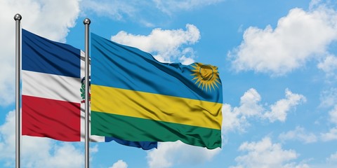 Dominican Republic and Rwanda flag waving in the wind against white cloudy blue sky together. Diplomacy concept, international relations.