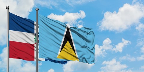 Dominican Republic and Saint Lucia flag waving in the wind against white cloudy blue sky together. Diplomacy concept, international relations.