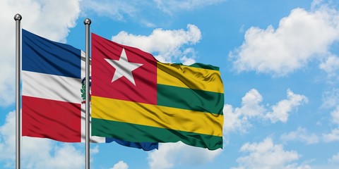 Dominican Republic and Togo flag waving in the wind against white cloudy blue sky together. Diplomacy concept, international relations.