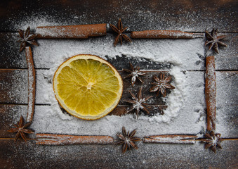 Christmas still life of dried oranges, cinnamon, star anise powdered sugar