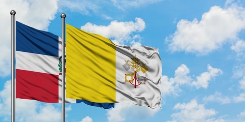 Dominican Republic and Vatican City flag waving in the wind against white cloudy blue sky together. Diplomacy concept, international relations.