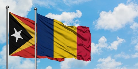 East Timor and Chad flag waving in the wind against white cloudy blue sky together. Diplomacy concept, international relations.