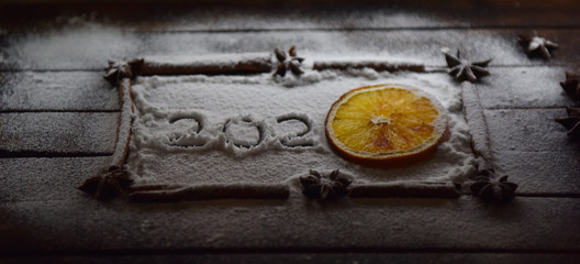 Christmas still life of dried oranges, cinnamon, star anise powdered sugar