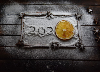 Christmas still life of dried oranges, cinnamon, star anise powdered sugar