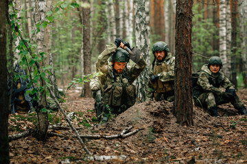 Soldiers on a halt. Preparing for the attack. Digging a trench.