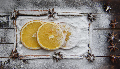 Christmas still life of dried oranges, cinnamon, star anise powdered sugar