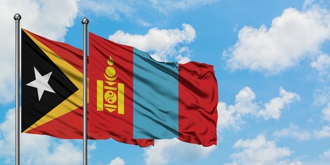 East Timor and Mongolia flag waving in the wind against white cloudy blue sky together. Diplomacy concept, international relations.