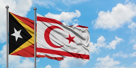East Timor and Northern Cyprus flag waving in the wind against white cloudy blue sky together. Diplomacy concept, international relations.