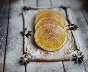 Christmas still life of dried oranges, cinnamon, star anise powdered sugar
