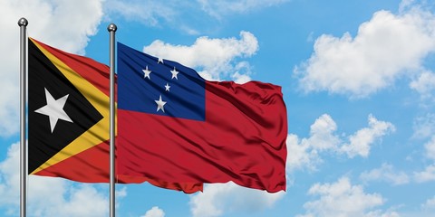 East Timor and Samoa flag waving in the wind against white cloudy blue sky together. Diplomacy concept, international relations.