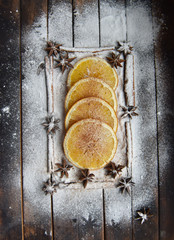 Christmas still life of dried oranges, cinnamon, star anise powdered sugar