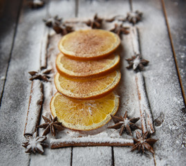 Christmas still life of dried oranges, cinnamon, star anise powdered sugar