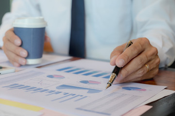 Businessmen, financial accountants, business planners, business planning ideas using computers, laptops, smat phones, and work calculators