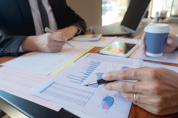 Businessmen, financial accountants, business planners, business planning ideas using computers, laptops, smat phones, and work calculators