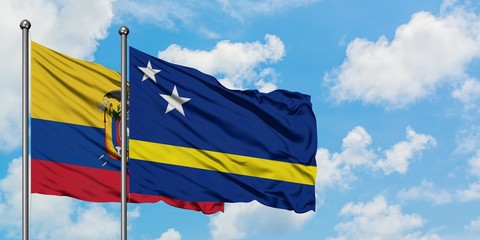 Ecuador and Curacao flag waving in the wind against white cloudy blue sky together. Diplomacy concept, international relations.