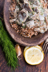 Stewed turkey stomachs with vegetables and buckwheat in a bowl